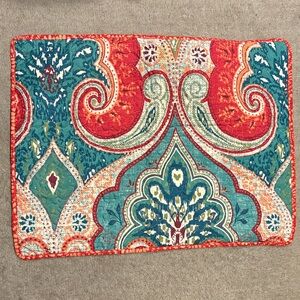 Reversible quilted pillow sham with a teal, red, and orange paisley print